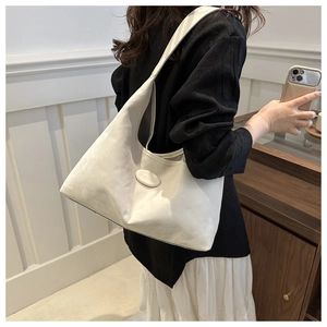 Close-up of a model wearing a soft white leather hobo bag for daily commuting