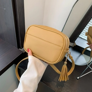 Vintage mustard yellow camera bag with litchi texture leather and tassel detail