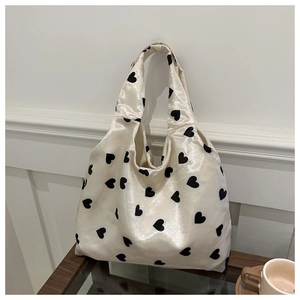Minimalist cream heart print satin tote bag with black patterns and sleek handle