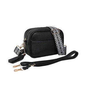 Retro black lychee grain crossbody bag with wide geometric strap and fringe charm