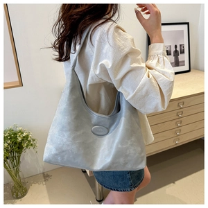 Detail shot of a grey large capacity Hobo shoulder bag in soft matte PU leather finish