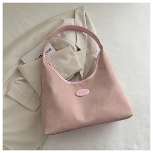 Pink PU leather hobo shoulder bag for women styled on a minimalist blazer background
