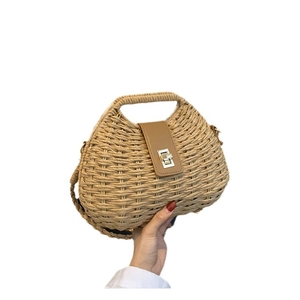 Retro woven straw handbag with a brown leather flap and a golden metal twist lock