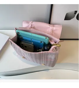 Interior view showing the large capacity of the pink checkered crossbody bag