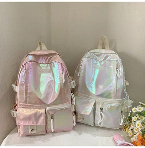 Detail view of pink and white holographic backpacks with multi-pocket design for students
