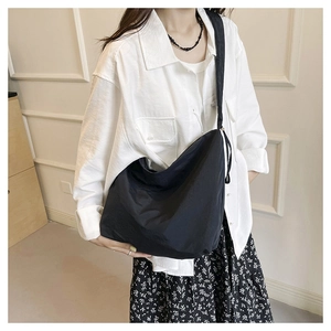 Detailed view of the black nylon hobo crossbody bag showing its large capacity and drape