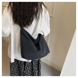 Close-up of black nylon hobo bag showing high capacity and soft pleated texture