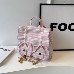 Pink plaid backpack with stylish leather bows and gold chain straps for commuting