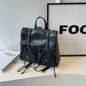 Vintage black bow backpack in soft faux leather with metallic gold chain straps