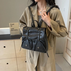Vintage black leather backpack with bow details and metal buckles for 2024 spring fashion