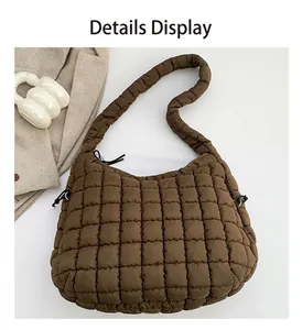 Detail of square quilted stitching on dark brown padded hobo bag with zipper closure