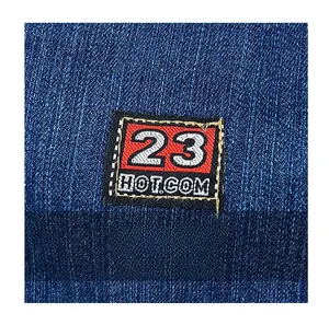 Close-up of the denim texture and embroidered number 23 patch on a shoulder bag