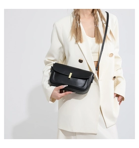 Detailed close-up of a black PU leather crossbody bag featuring a gold rectangular metal lock