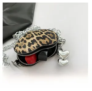 Detail of leopard print crossbody bag with silver chain, pearl and heart charm