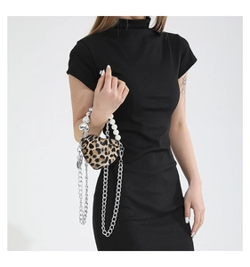 Detail of heart-shaped leopard print bag with pearl chain and silver metal strap