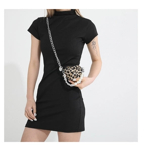 Detail of leopard print heart-shaped crossbody bag with silver chain and pearl strap