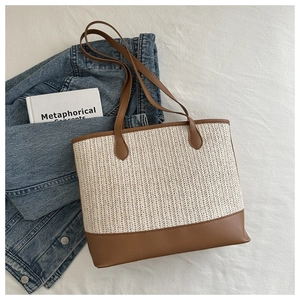 Chic woven straw tote bag with brown leather handles for women's spring fashion