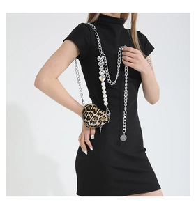 Detail of leopard print heart-shaped PU bag with pearl and silver chain shoulder strap