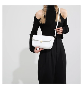 Minimalist white PU leather crossbody bag with a sleek gold rectangular clasp on model