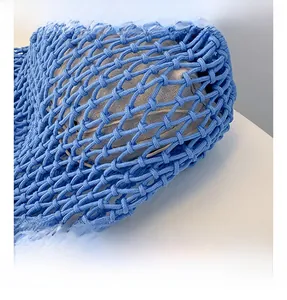Macro shot of royal blue woven mesh bag showing thick cotton rope and beige lining texture