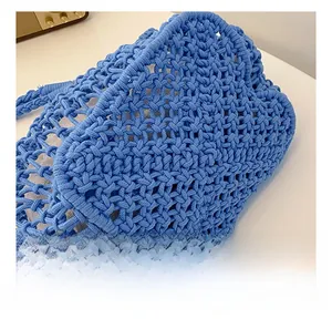 Detailed macro view showing the blue woven mesh texture and cotton lining of the tote bag