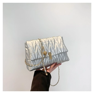 Silver quilted PU crossbody bag with golden chain strap and wavy metallic texture