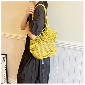 Detail of yellow woven mesh beach bag with cotton lining and durable shoulder strap