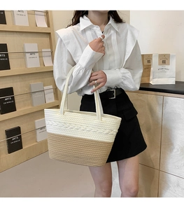 Detail of woven fabric shoulder bag featuring beige and coffee brown stitching textures