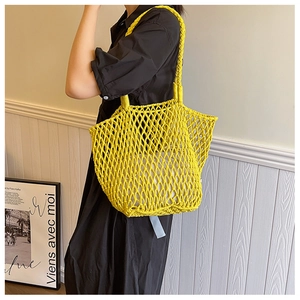 Close-up of bright yellow woven tote bag with thick cotton rope and inner drawstring