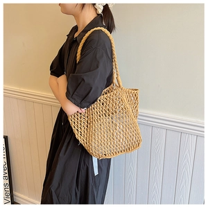 Detail of hand-woven ginger yellow mesh tote bag with rustic texture and soft white lining