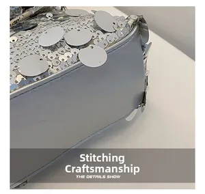 Macro detail of silver sequin bag showing grey leather base and precise stitching craft