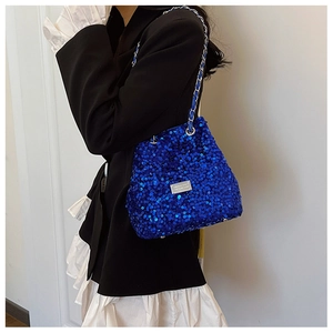 Detailed view of shiny blue sequin bucket bag with silver metal chain strap