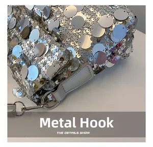 Detail of silver sequined bag featuring a sturdy swivel metal hook for shoulder strap