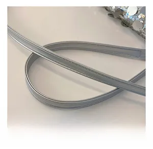 Close-up of the silver faux leather strap with fine stitching on a sequined crossbody bag