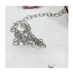 Close-up of shiny silver metal chain strap with polished oval links for a PU leather bag