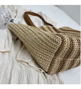 Close-up of the beige and brown striped woven texture and PU leather handle details