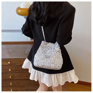 Detailed view of the sparkling silver sequin bucket bag with elegant metallic chain strap