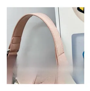 Detail of pink PU leather handbag with silver metal buckle and reinforced stitching