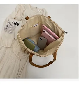 Top view of woven tote bag interior showing large capacity with pockets and tablet storage