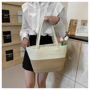 Detail of woven fabric tote bag with bicolor texture and stylish top handle design