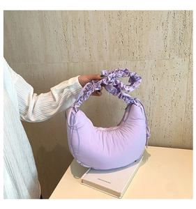 Detail of lavender crescent cloud bag with quilted fabric and ruffled shoulder strap