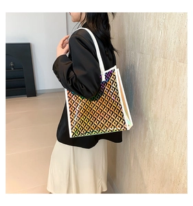 Close-up of holographic tote bag with heart patterns shown on a female model
