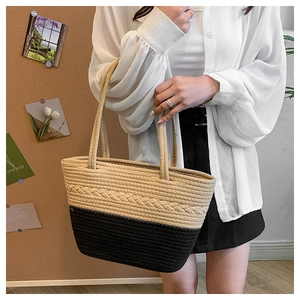 Detailed macro view of woven beige and black texture on the stylish tote bag