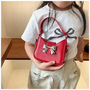 Detail of red child PU handbag with silver metallic bow and metal chain strap