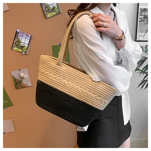 Detailed macro view showing the textured two-tone woven fabric and braided pattern of the tote