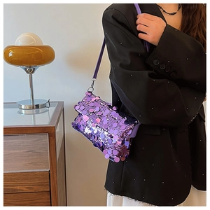 Close-up of purple sequin crossbody bag texture with reflective circular sequins