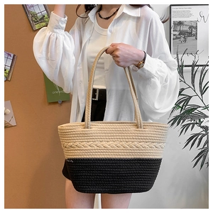 Close-up of handmade woven tote bag with contrast stitching and decorative braid detail