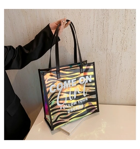 Detailed macro of holographic zebra stripe texture on this PU tote bag with artistic text