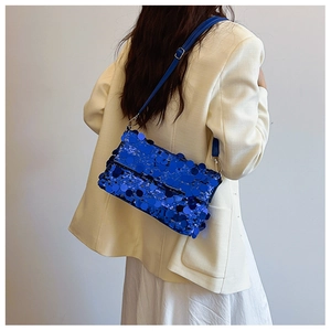 Detailed view of the sparkling blue sequin crossbody bag with a blue leather strap for women