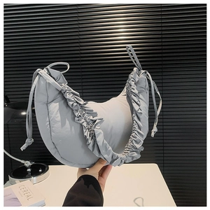 Minimalist light grey crescent crossbody bag with puffy pleated straps and drawstring details